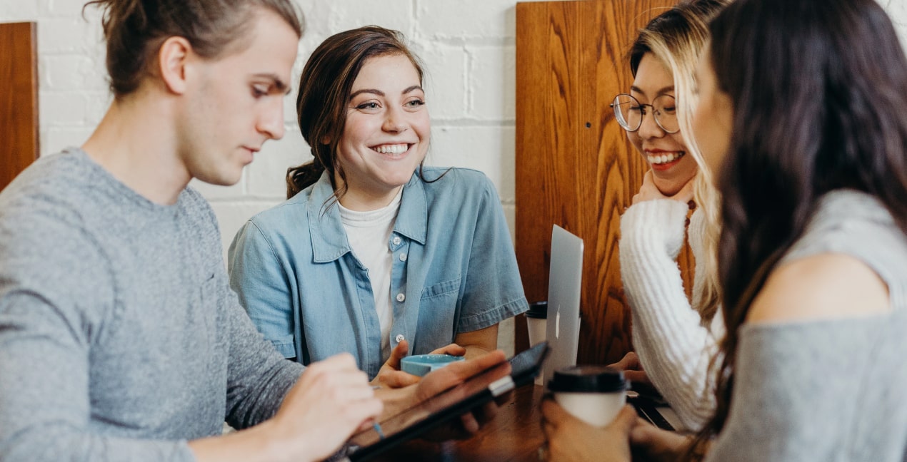 3 people smiling and talking to each other
